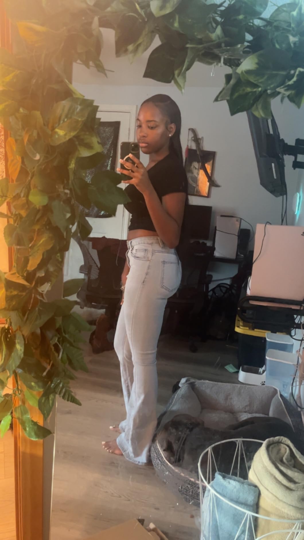 Full length mirror shot of a straight low ponytail reaching past the waist